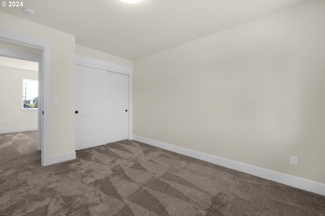 unfurnished bedroom with a closet and carpet