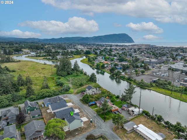 drone / aerial view with a water and mountain view