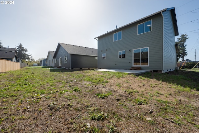 back of property with a patio and a lawn