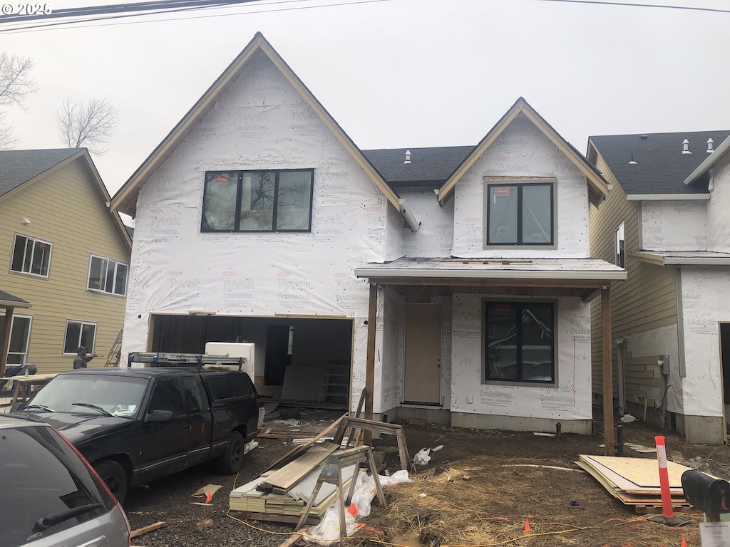 property in mid-construction with a garage and a porch