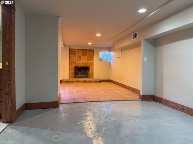 unfurnished living room with a tile fireplace