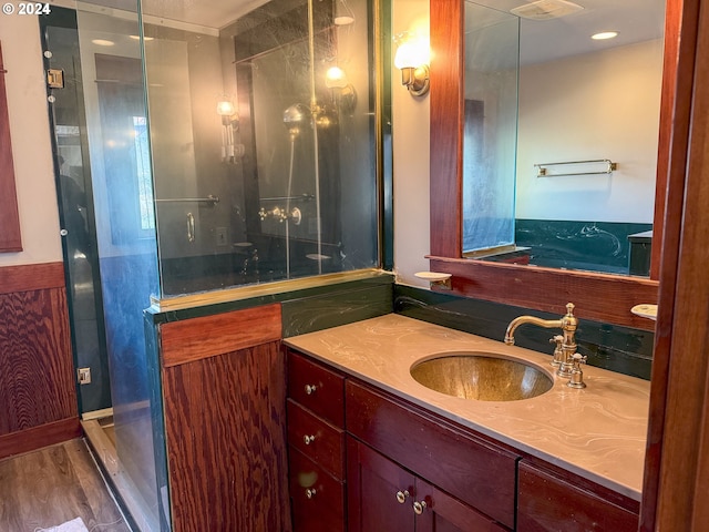 bathroom featuring vanity, hardwood / wood-style floors, and a shower