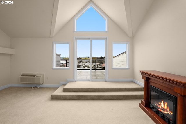 carpeted living area featuring high vaulted ceiling, a glass covered fireplace, an AC wall unit, and baseboards