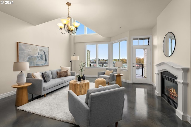 living area with a glass covered fireplace, a notable chandelier, plenty of natural light, and baseboards