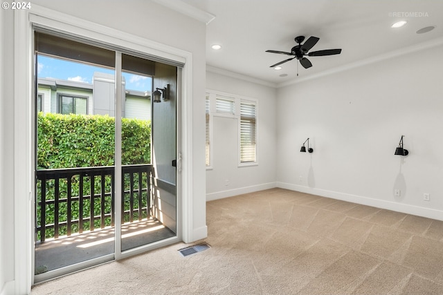 unfurnished room with crown molding, ceiling fan, and light carpet