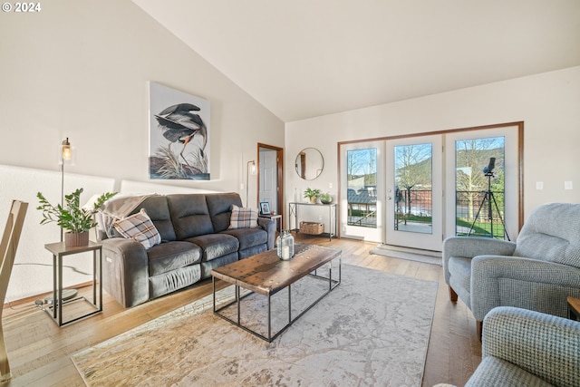 living room featuring light hardwood / wood-style flooring and high vaulted ceiling