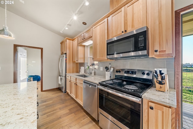 kitchen featuring sink, light hardwood / wood-style flooring, light brown cabinetry, decorative light fixtures, and stainless steel appliances