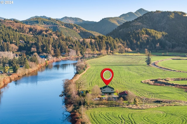 drone / aerial view with a rural view and a water and mountain view