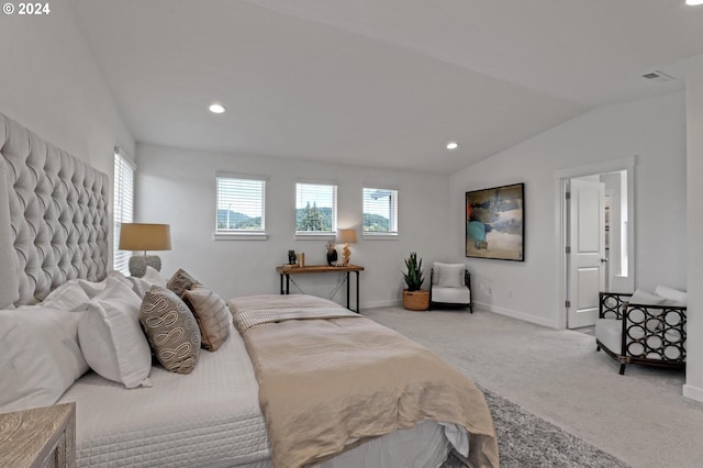 bedroom featuring vaulted ceiling and light colored carpet