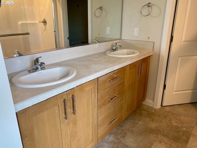 bathroom featuring double vanity and a sink