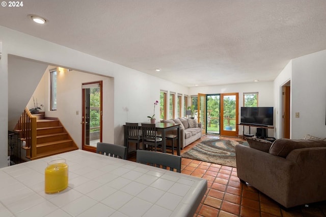 living room featuring tile patterned floors and a textured ceiling