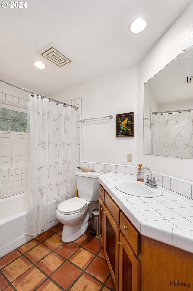 full bathroom with shower / bath combination with curtain, vanity, and toilet