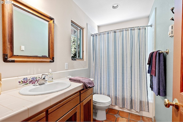 full bathroom featuring tile patterned floors, vanity, toilet, and shower / bath combo with shower curtain