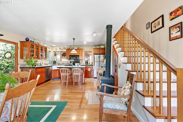 interior space featuring light hardwood / wood-style floors and a wood stove