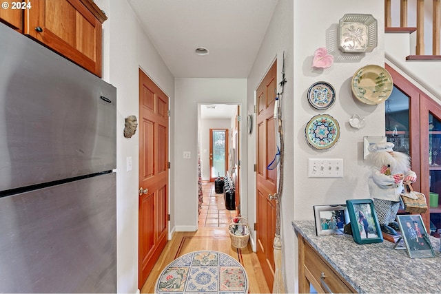 corridor with light hardwood / wood-style flooring