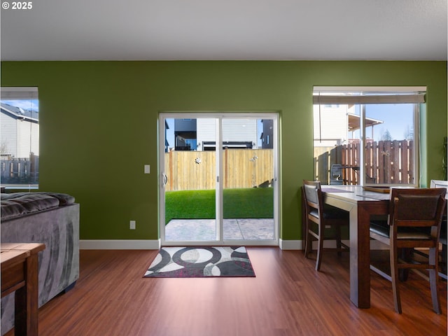 doorway to outside featuring dark wood-type flooring