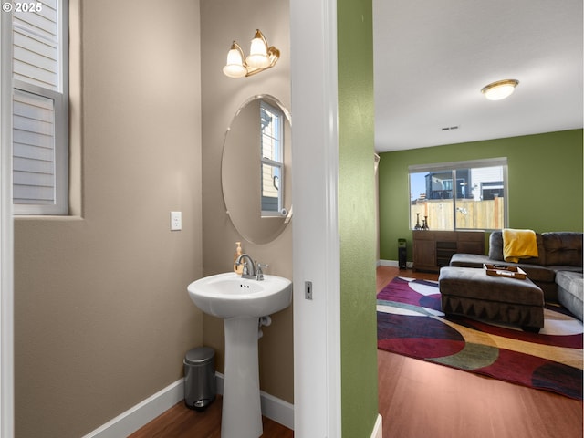 bathroom featuring hardwood / wood-style flooring, plenty of natural light, and sink