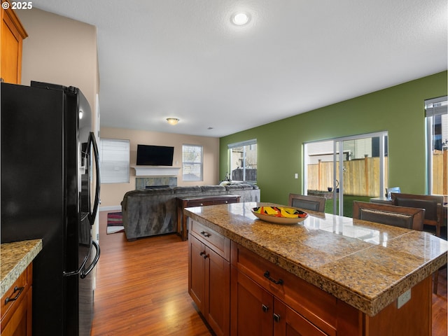 kitchen featuring black fridge, light hardwood / wood-style floors, and a kitchen island