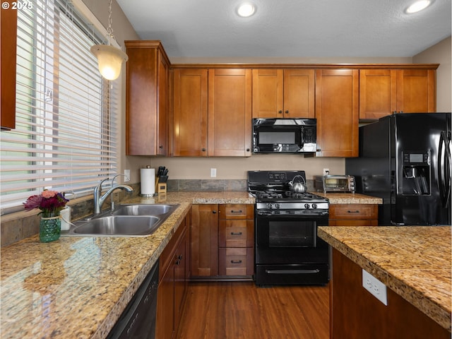 kitchen with a healthy amount of sunlight, sink, dark hardwood / wood-style floors, and black appliances