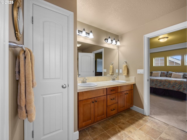 bathroom with vanity, tile patterned flooring, and a textured ceiling