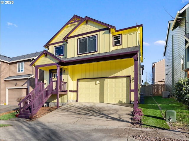 view of front of house featuring central AC unit, a garage, a front yard, and a porch