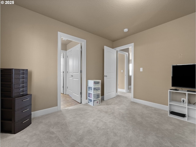 unfurnished bedroom with light carpet and a textured ceiling