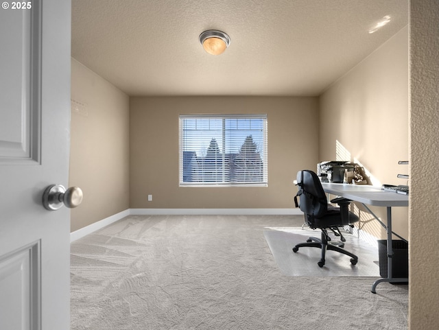 office space featuring light carpet and a textured ceiling