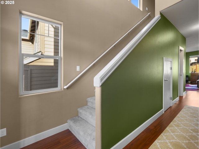 stairs featuring hardwood / wood-style floors