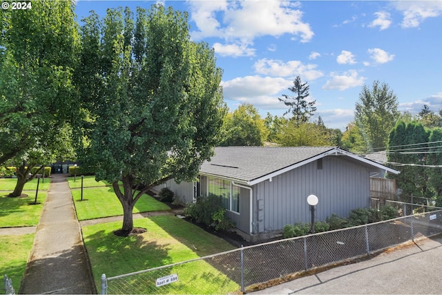 view of side of home with a lawn