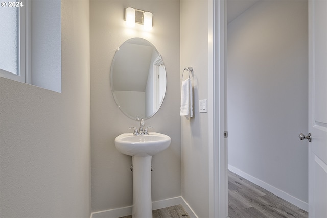 bathroom with wood-type flooring and sink