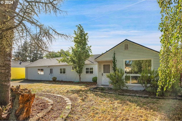 back of house with a yard and a patio