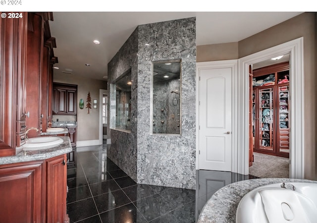 full bathroom with granite tiled floors, walk in shower, vanity, baseboards, and recessed lighting