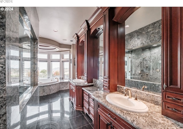 full bath featuring a bath, two vanities, and recessed lighting