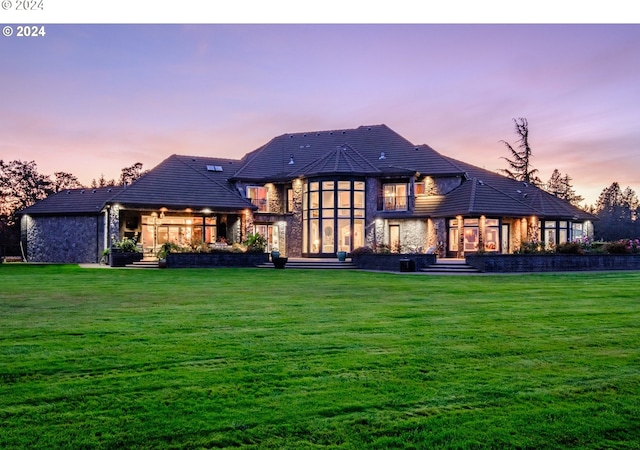 back house at dusk with a yard