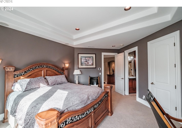 bedroom with light colored carpet, a raised ceiling, baseboards, and recessed lighting