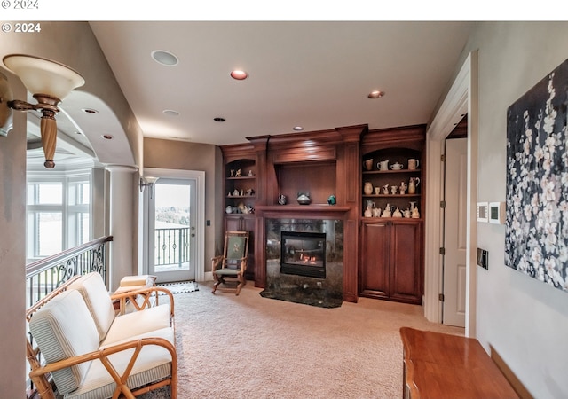 living area featuring light carpet, a fireplace, and recessed lighting