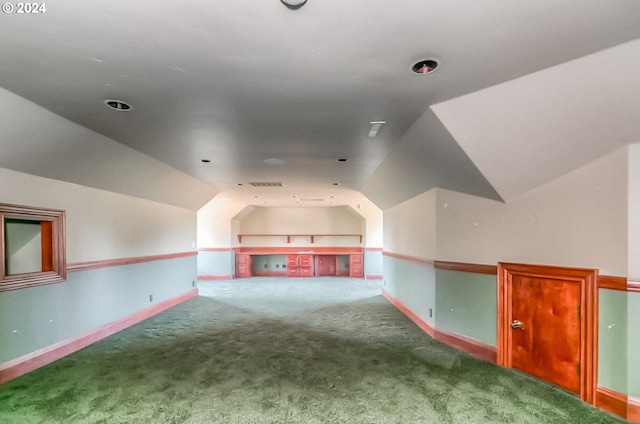 additional living space featuring lofted ceiling and carpet flooring