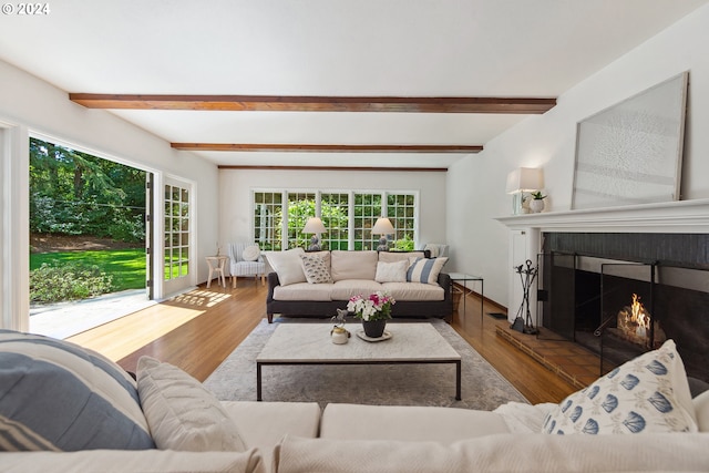 living room featuring light hardwood / wood-style flooring and beamed ceiling