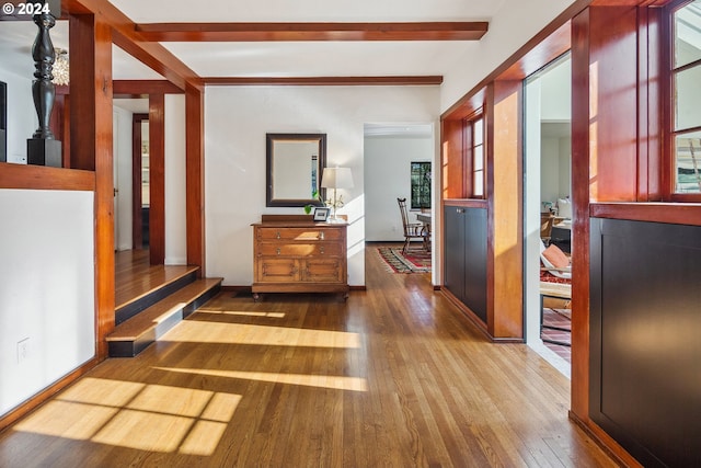 hallway featuring hardwood / wood-style flooring and beamed ceiling