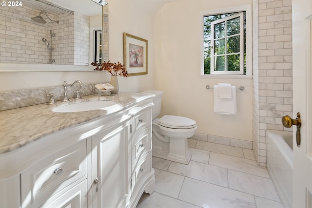 full bathroom featuring toilet, tiled shower / bath, and vanity