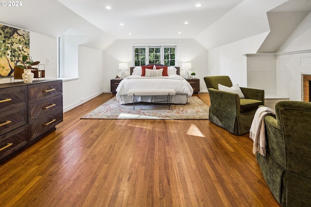 bedroom featuring vaulted ceiling and dark hardwood / wood-style flooring