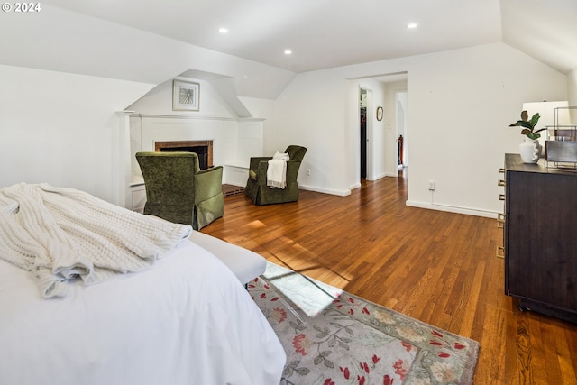 bedroom featuring dark hardwood / wood-style flooring and lofted ceiling