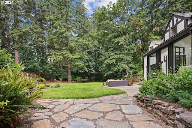 view of yard featuring a patio area, a hot tub, and an outdoor hangout area