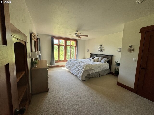 carpeted bedroom with ceiling fan