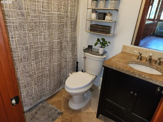 bathroom with tile patterned flooring, vanity, and toilet