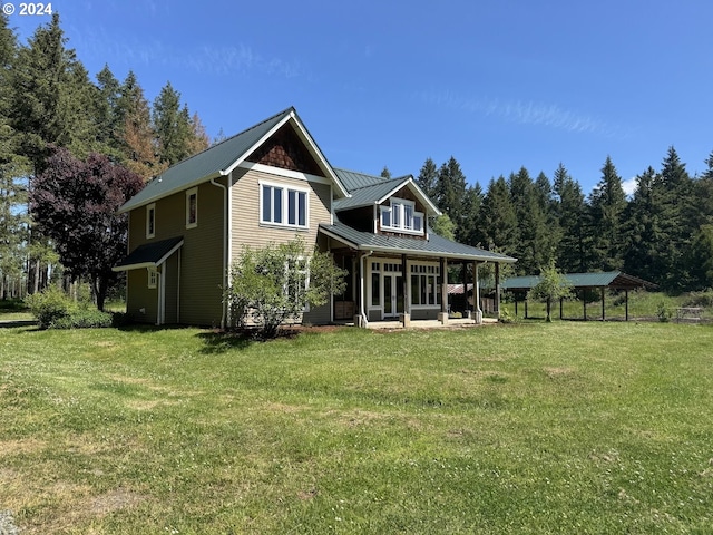 rear view of house featuring a yard and a gazebo