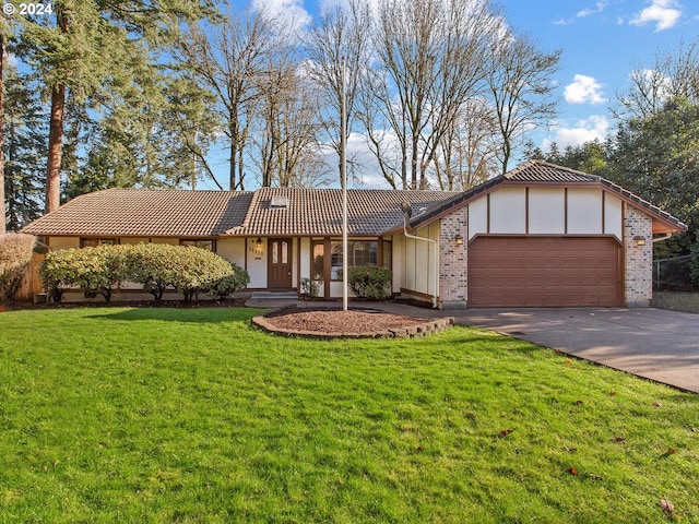 ranch-style home featuring a garage and a front yard