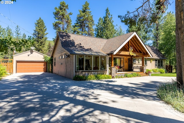 view of front of home featuring an outbuilding, a porch, and a garage