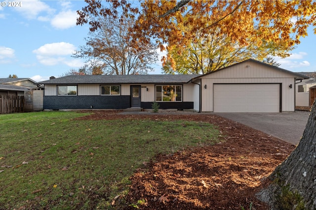 ranch-style home featuring a garage and a front lawn