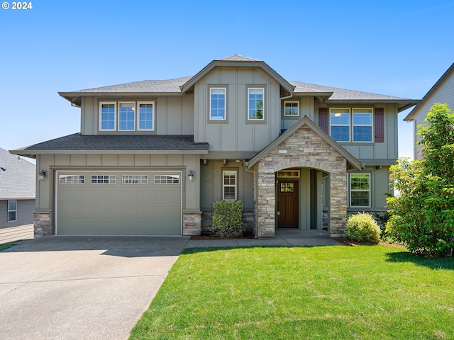 craftsman inspired home with a garage and a front lawn